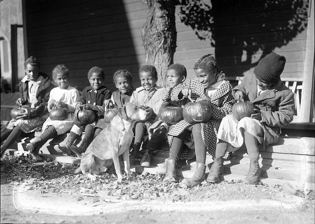 The children get ready to carve up their jack-o-lanterns. Fifth from left is Victor Jackson. [PHOTO: Albert R. Stone]